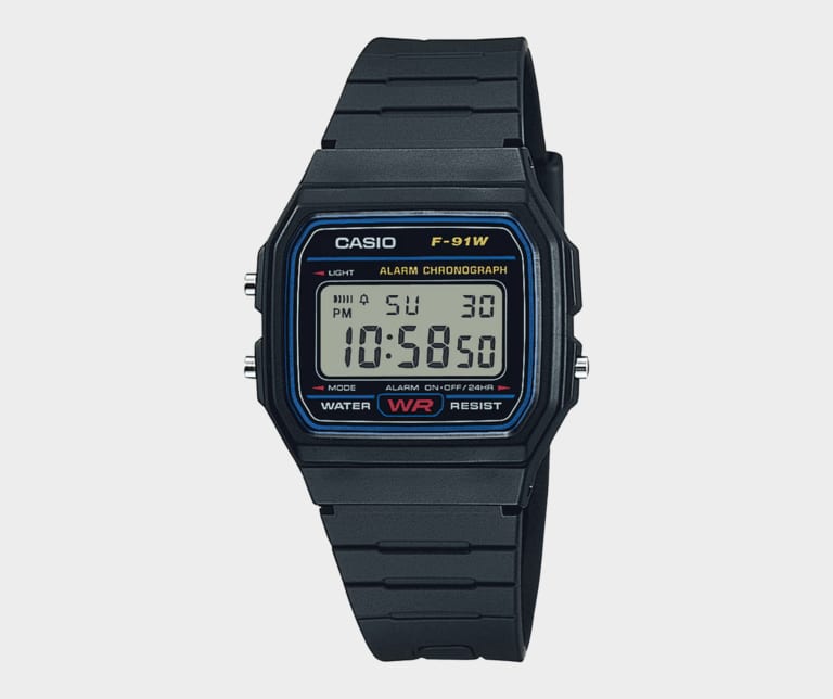 A black Casio F91 digital wristwatch displaying the time 10:58:30 on its screen, known for zero updates over thirty-five years.